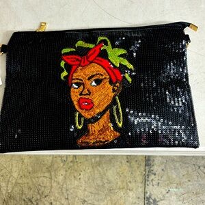 Black Sequin clutch tote with strap. Lined  zipper compartment. 13’W X 9 1/4 H